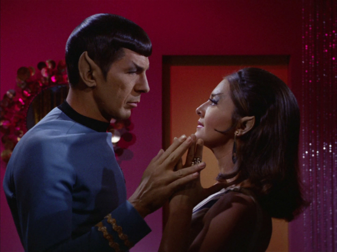 a screenshot of the Star Trek Episode The Enterprise Incident depicting Spock and the hot Romulan commander touching hands suggestively